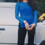 Transparent long sleeve meh top with flared pants under serene suitcase