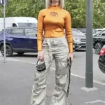 a fitted long-sleeve top and cargo pants under serene suitcase